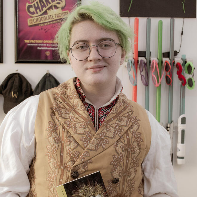 Brie, dressed as Pierre Bezukhov from Natasha, Pierre, and the Great Comet of 1812, looking into the camera.