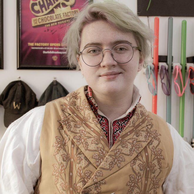 Brie, dressed as Jimmy Olsen from Superman (2025), looking into a camera.