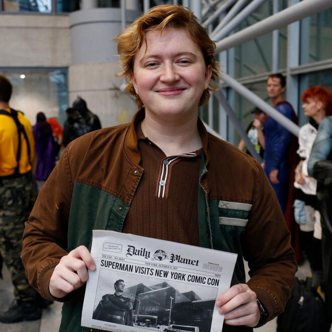 Brie, dressed as Jimmy Olsen from Superman (2025), looking into a camera at New York Comic Con.
